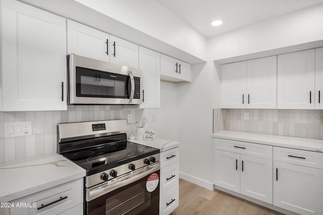 kitchen featuring white cabinetry, light hardwood / wood-style flooring, and stainless steel appliances