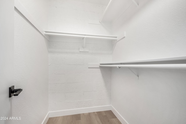 spacious closet featuring hardwood / wood-style floors