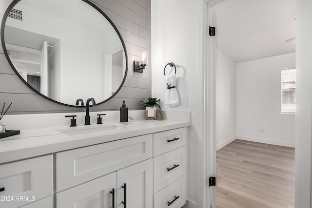 bathroom with vanity and wood-type flooring