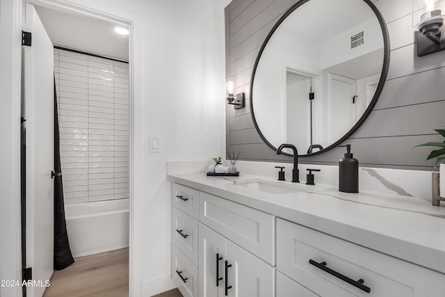 bathroom featuring shower / bath combo with shower curtain, vanity, and wood-type flooring