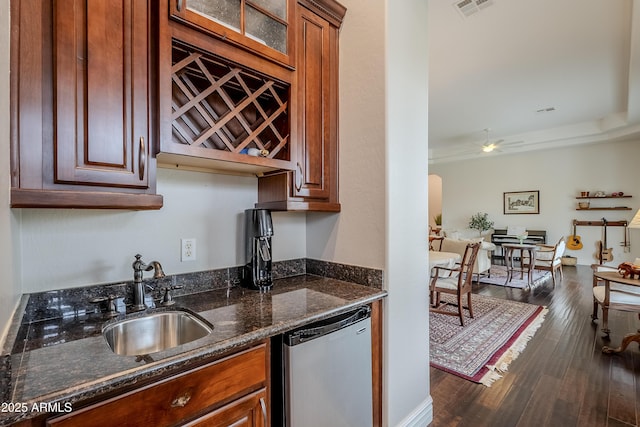 kitchen with ceiling fan, dishwasher, sink, dark hardwood / wood-style flooring, and dark stone countertops