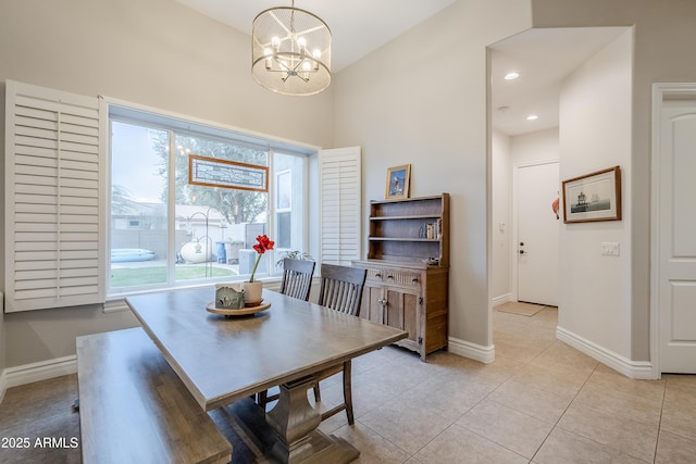 tiled dining room featuring a chandelier