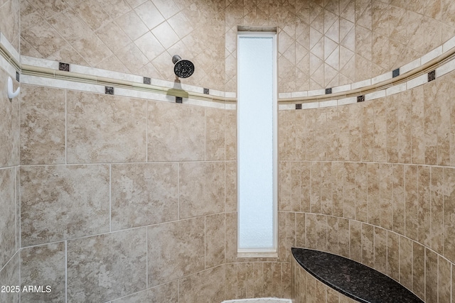 interior details with a tile shower