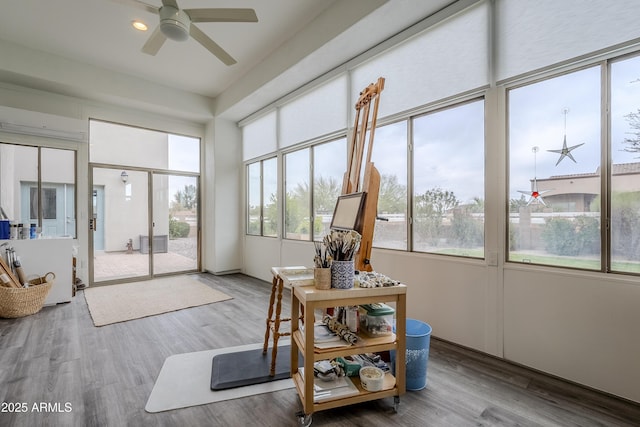 sunroom featuring ceiling fan