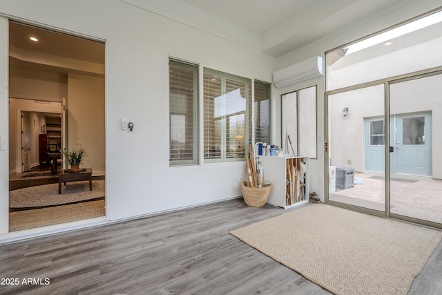 sunroom featuring a wall mounted air conditioner