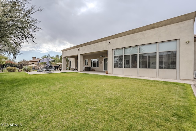 rear view of house featuring a lawn, a patio area, ceiling fan, and cooling unit