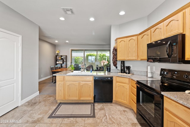 kitchen with kitchen peninsula, light brown cabinets, black appliances, and sink