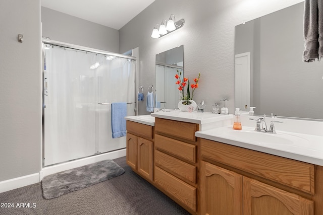 bathroom with vanity and a shower with door