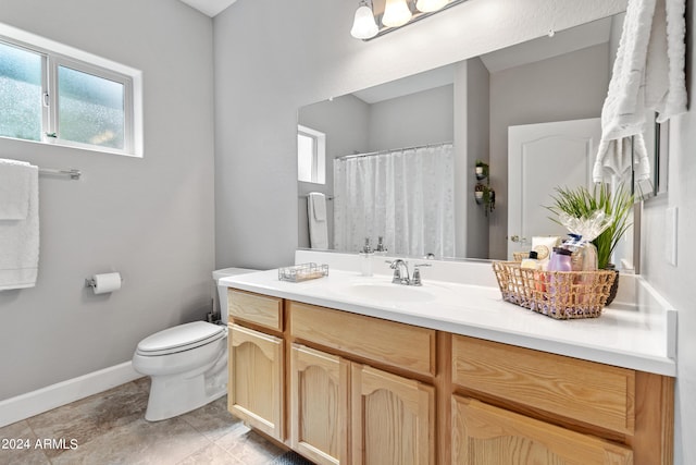 bathroom featuring toilet and vanity