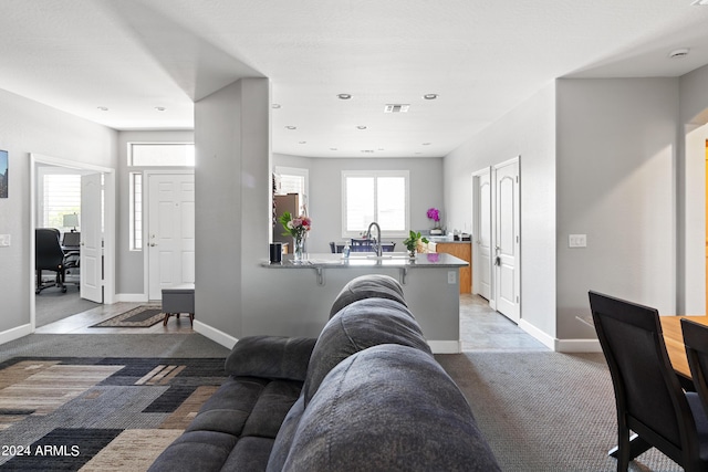 tiled living room featuring sink