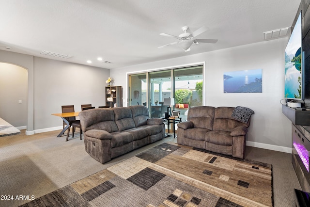 living room with ceiling fan and light colored carpet