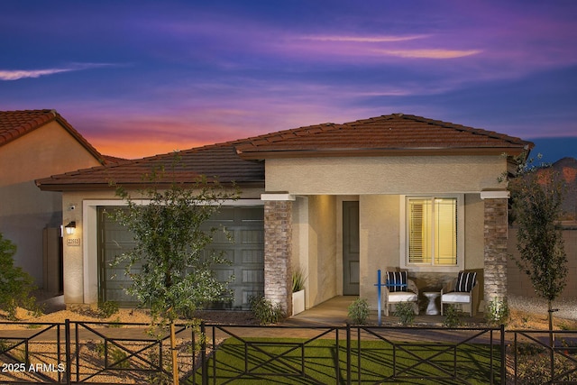 back house at dusk with a garage