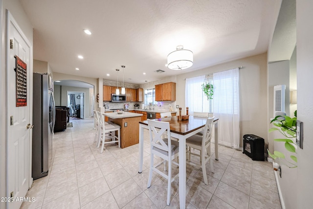 dining room featuring visible vents, light tile patterned floors, recessed lighting, and arched walkways