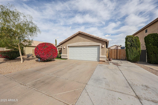 exterior space featuring stucco siding, driveway, a tile roof, and fence