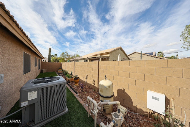 view of yard featuring central AC unit and a fenced backyard