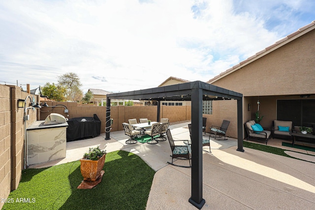 view of patio / terrace featuring a gazebo, grilling area, an outdoor hangout area, and a fenced backyard