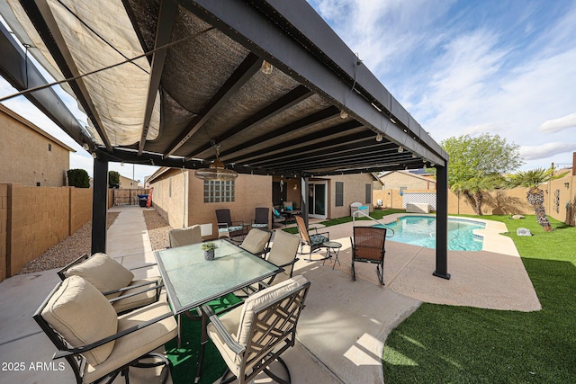 view of patio / terrace featuring outdoor dining space, a fenced in pool, and a fenced backyard