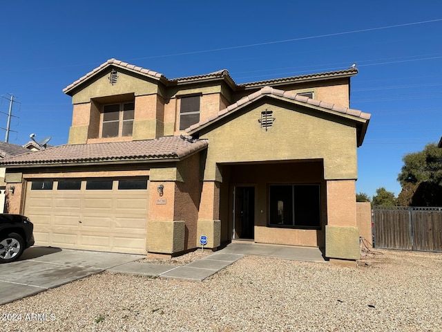 9406 W Elwood St, Tolleson, AZ 85353 - view of front facade featuring stucco siding, concrete driveway, and a tile roof