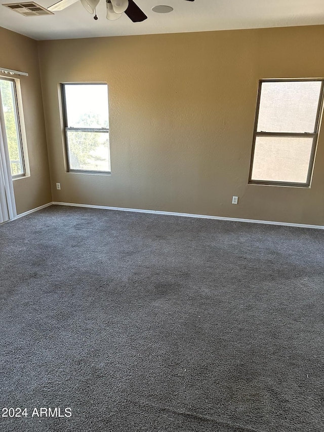 unfurnished room featuring ceiling fan and carpet floors