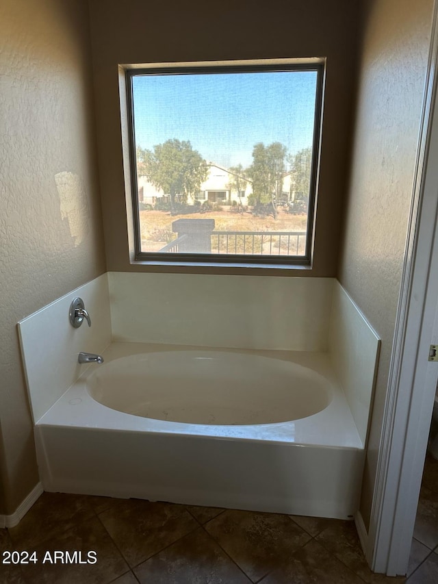 bathroom featuring a bath and tile patterned flooring