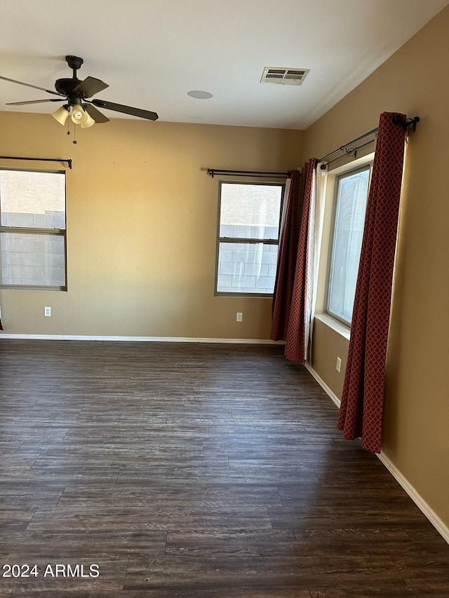 empty room featuring dark hardwood / wood-style floors and ceiling fan