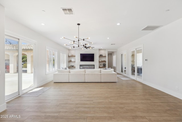 3356 E Vallejo Ct, Gilbert, AZ 85298 - unfurnished living room featuring visible vents, an inviting chandelier, light wood-style floors, and recessed lighting