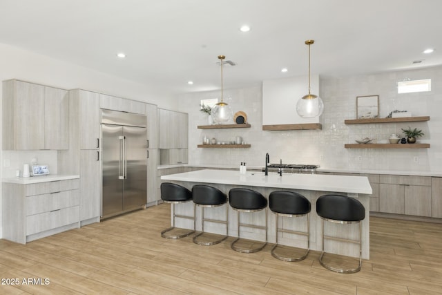 3356 E Vallejo Ct, Gilbert, AZ 85298 - kitchen with stainless steel built in refrigerator, a kitchen breakfast bar, open shelves, and modern cabinets