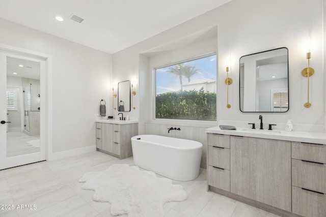 3356 E Vallejo Ct, Gilbert, AZ 85298 - bathroom featuring a soaking tub, a shower stall, a sink, visible vents, and two vanities