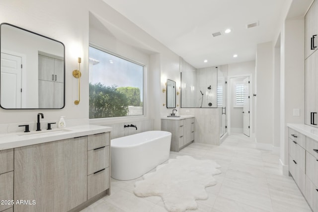 3356 E Vallejo Ct, Gilbert, AZ 85298 - full bath with a freestanding bath, two vanities, a sink, visible vents, and a stall shower