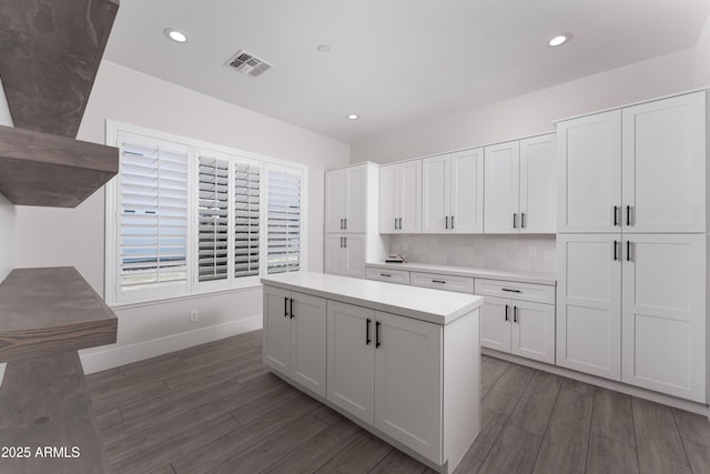 3356 E Vallejo Ct, Gilbert, AZ 85298 - kitchen with visible vents, white cabinets, wood finished floors, and light countertops