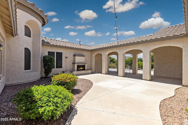 3356 E Vallejo Ct, Gilbert, AZ 85298 - view of patio with a lit fireplace