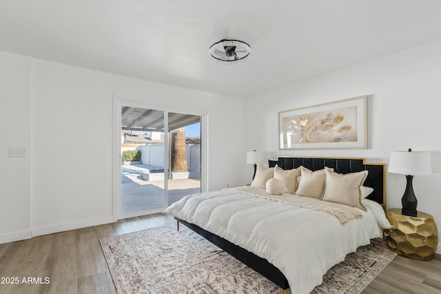 bedroom with light wood-type flooring and access to exterior