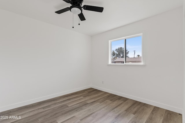 spare room with light wood-type flooring and ceiling fan