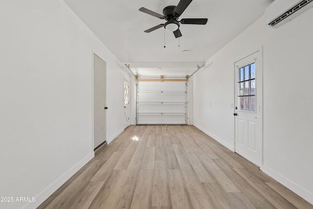 garage featuring ceiling fan and a wall mounted air conditioner