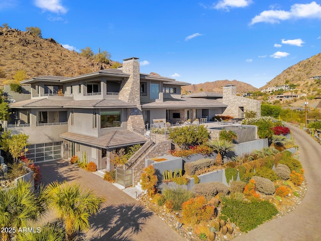 back of property featuring a garage and a mountain view