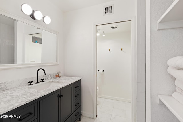 bathroom with toilet and vanity