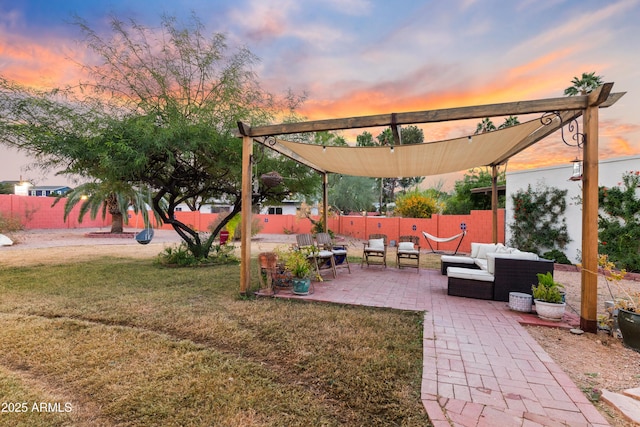 yard at dusk with a patio area and an outdoor living space