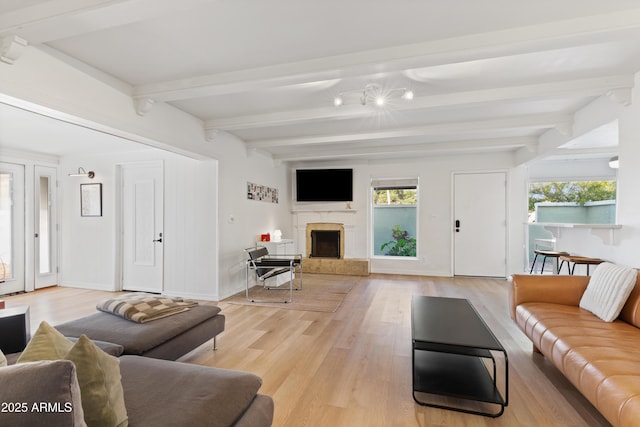 living room with light wood-type flooring and beamed ceiling