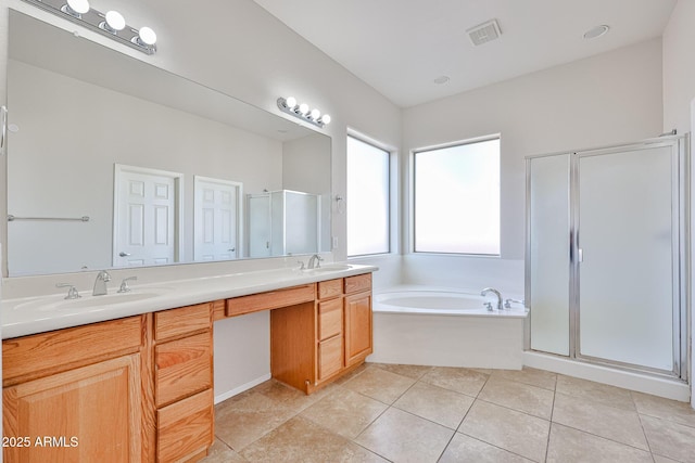 bathroom featuring tile patterned floors, a sink, a shower stall, and a bath