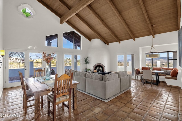 living room featuring beam ceiling, high vaulted ceiling, and wood ceiling