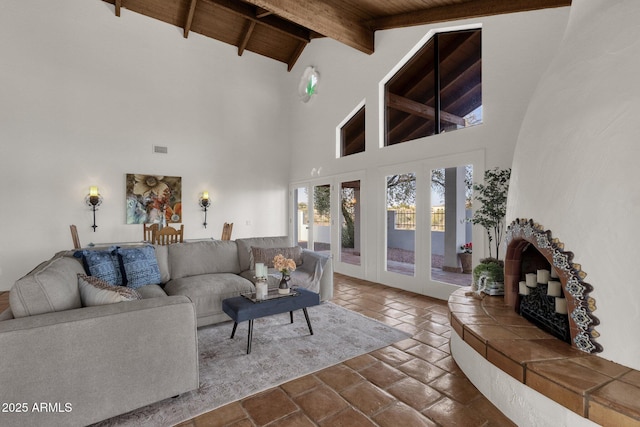 living room featuring beamed ceiling, high vaulted ceiling, and wooden ceiling