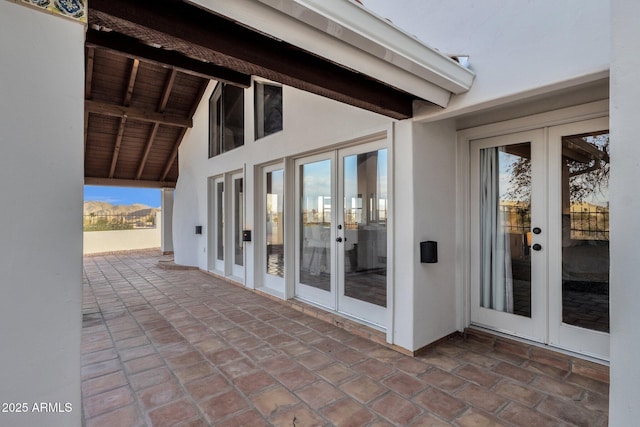 view of patio / terrace featuring a mountain view and french doors