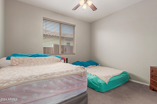 bedroom featuring ceiling fan and carpet