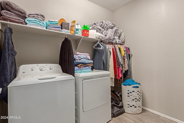 washroom featuring washer and dryer and light wood-type flooring