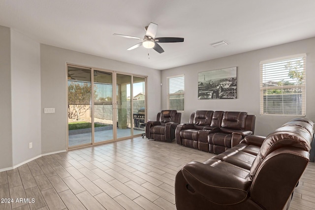 living room featuring ceiling fan and light hardwood / wood-style flooring