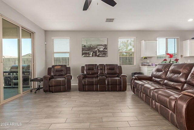 living room with light wood-type flooring and ceiling fan