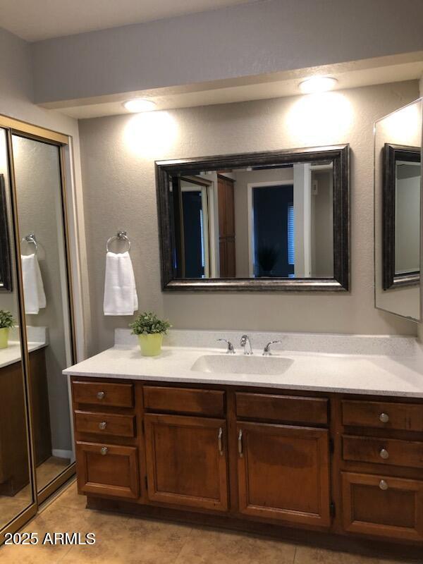 bathroom featuring tile patterned flooring and vanity