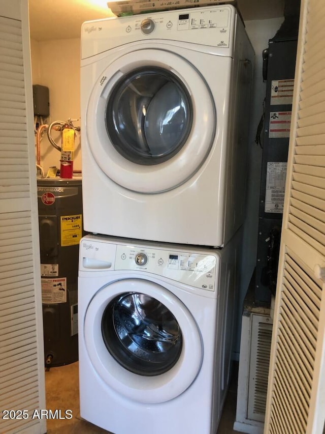 washroom with laundry area, electric water heater, and stacked washing maching and dryer