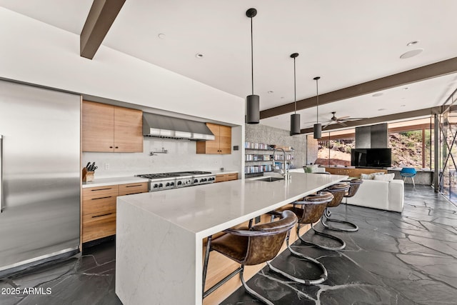 4925 E Red Rock Dr Unit 43, Phoenix, AZ 85018 - kitchen featuring wall chimney range hood, beamed ceiling, dark marble finish floors, a ceiling fan, and modern cabinets