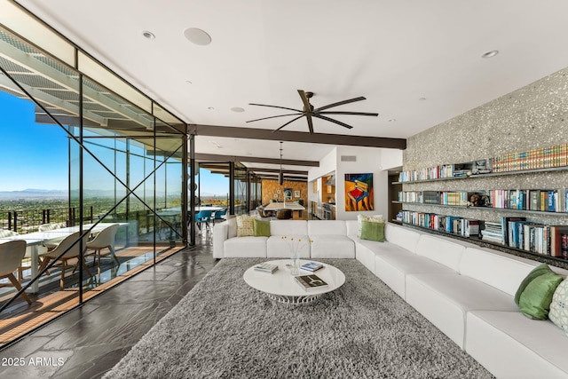 4925 E Red Rock Dr Unit 43, Phoenix, AZ 85018 - living area with a ceiling fan, stone finish floors, expansive windows, and a mountain view